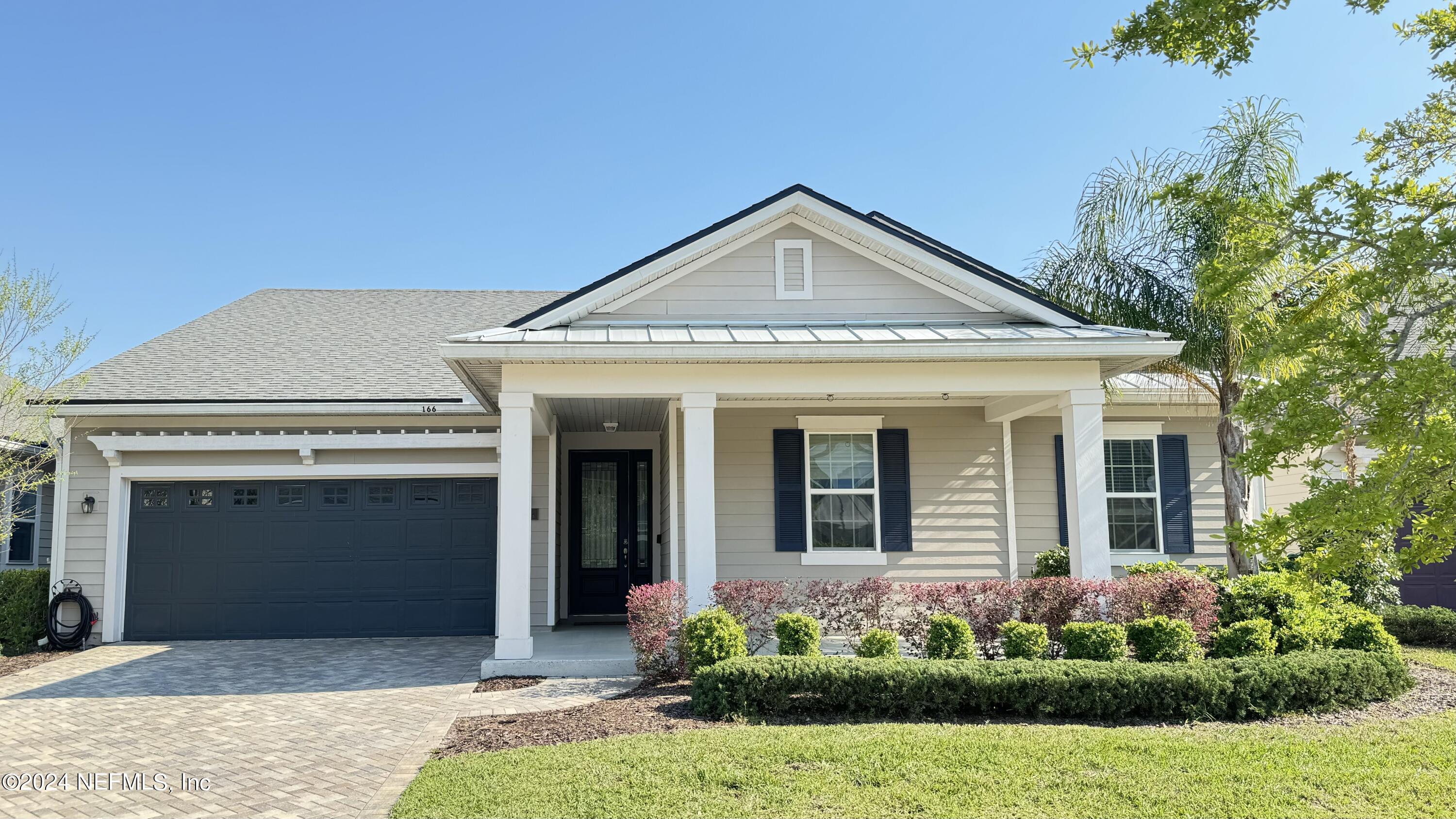 166 Palisade Drive St. Augustine, FL 32092 - Photo 1 of 8 a front view of a house with garden