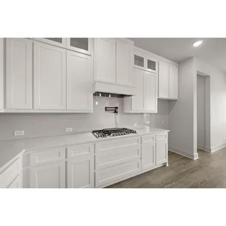 a kitchen with kitchen island a sink stainless steel appliances and cabinets