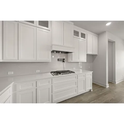 a kitchen with kitchen island a sink stainless steel appliances and cabinets