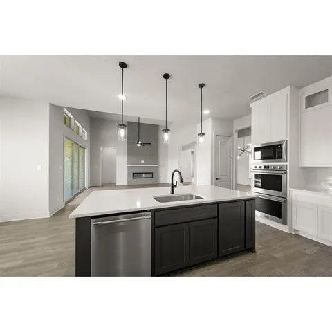 a living room with a large window and chandelier