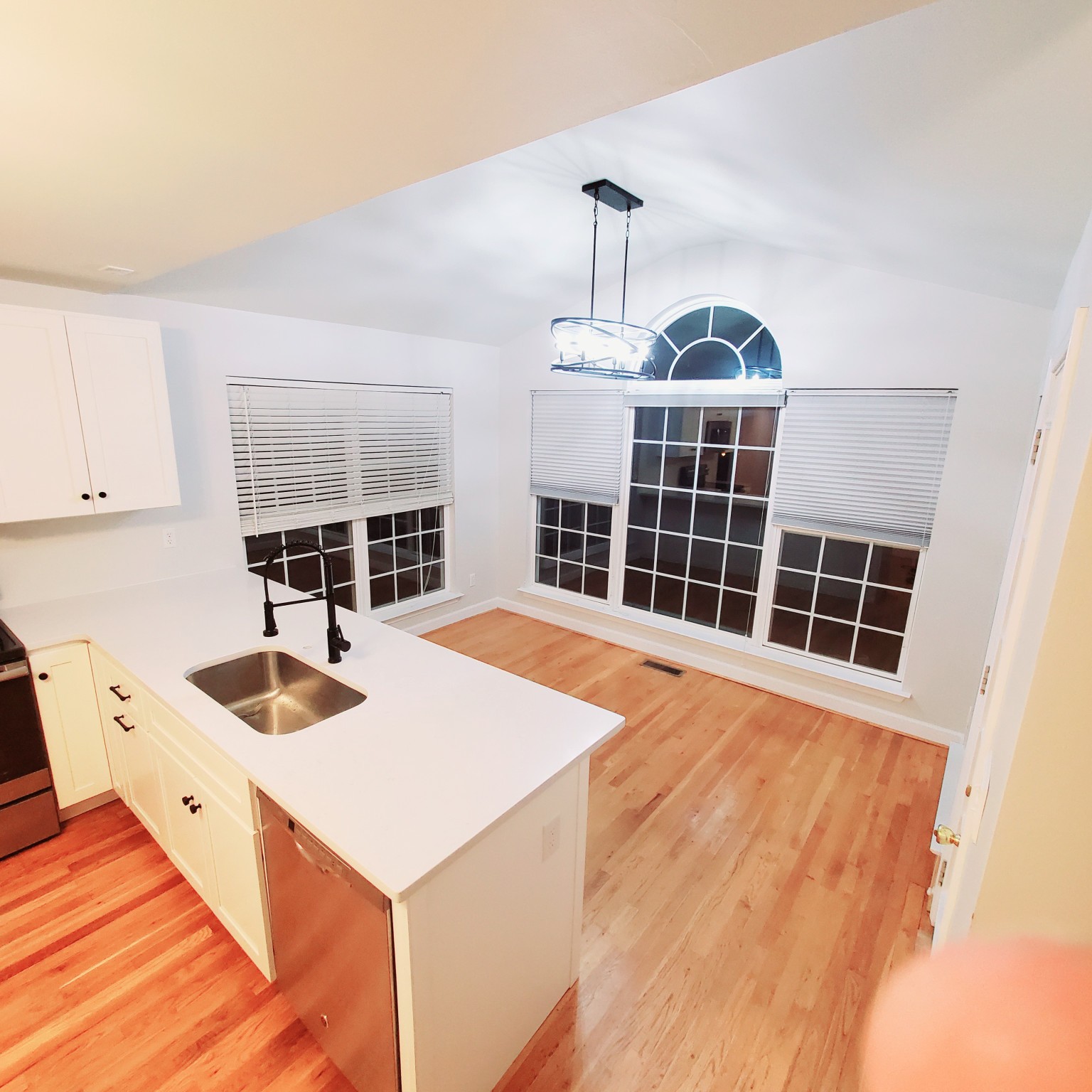 a view of a kitchen with a sink and cabinets
