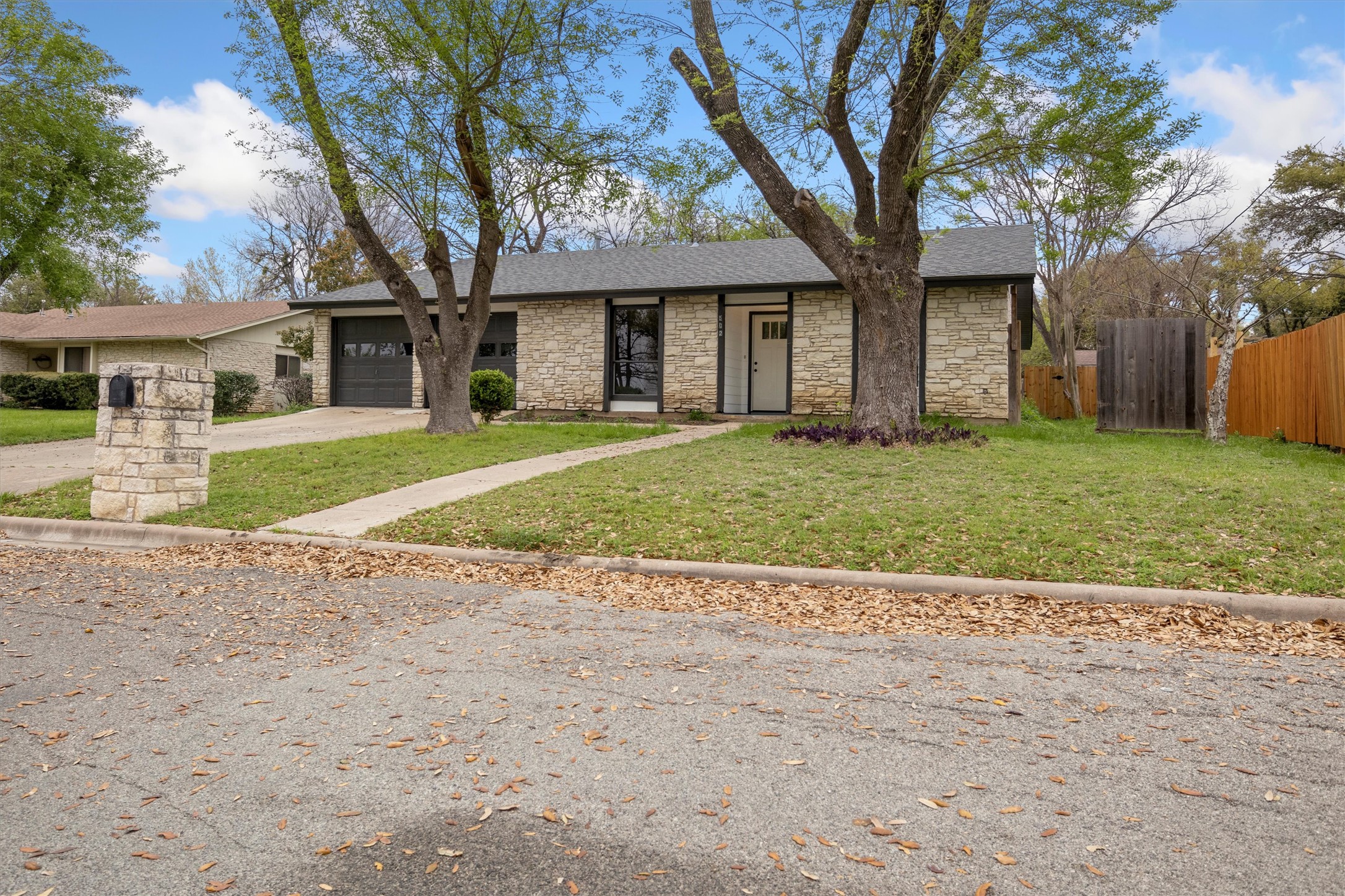 502 Pin Tail Lane Taylor, TX 76574 - Photo 25 of 26 Stone veneer exterior featuring a dark asphalt shingle roof