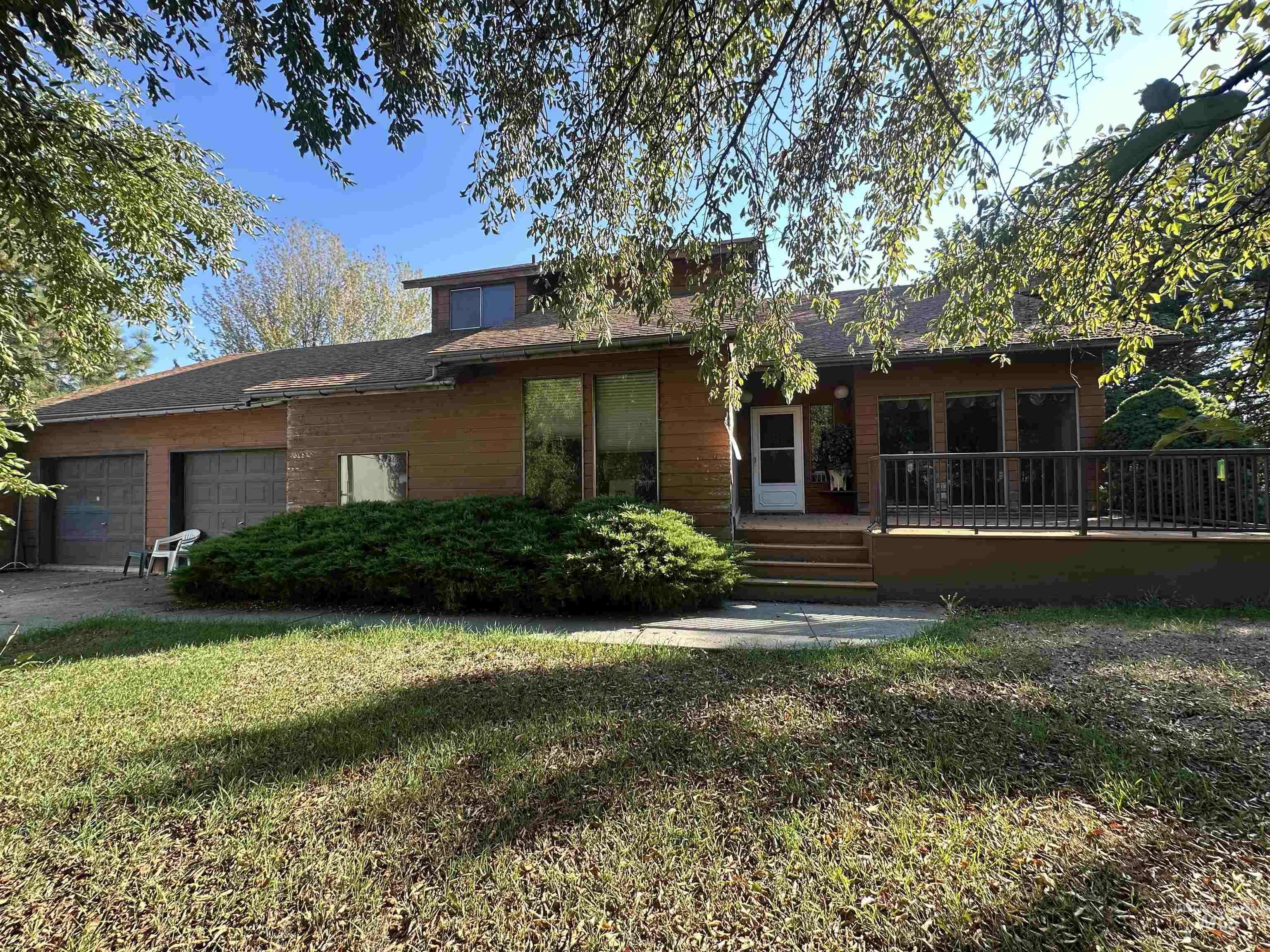 811 Florence Avenue Craigmont, ID 83523 - Photo 2 of 48 View of front of house with a front lawn, an attached garage, roof with shingles, and a deck