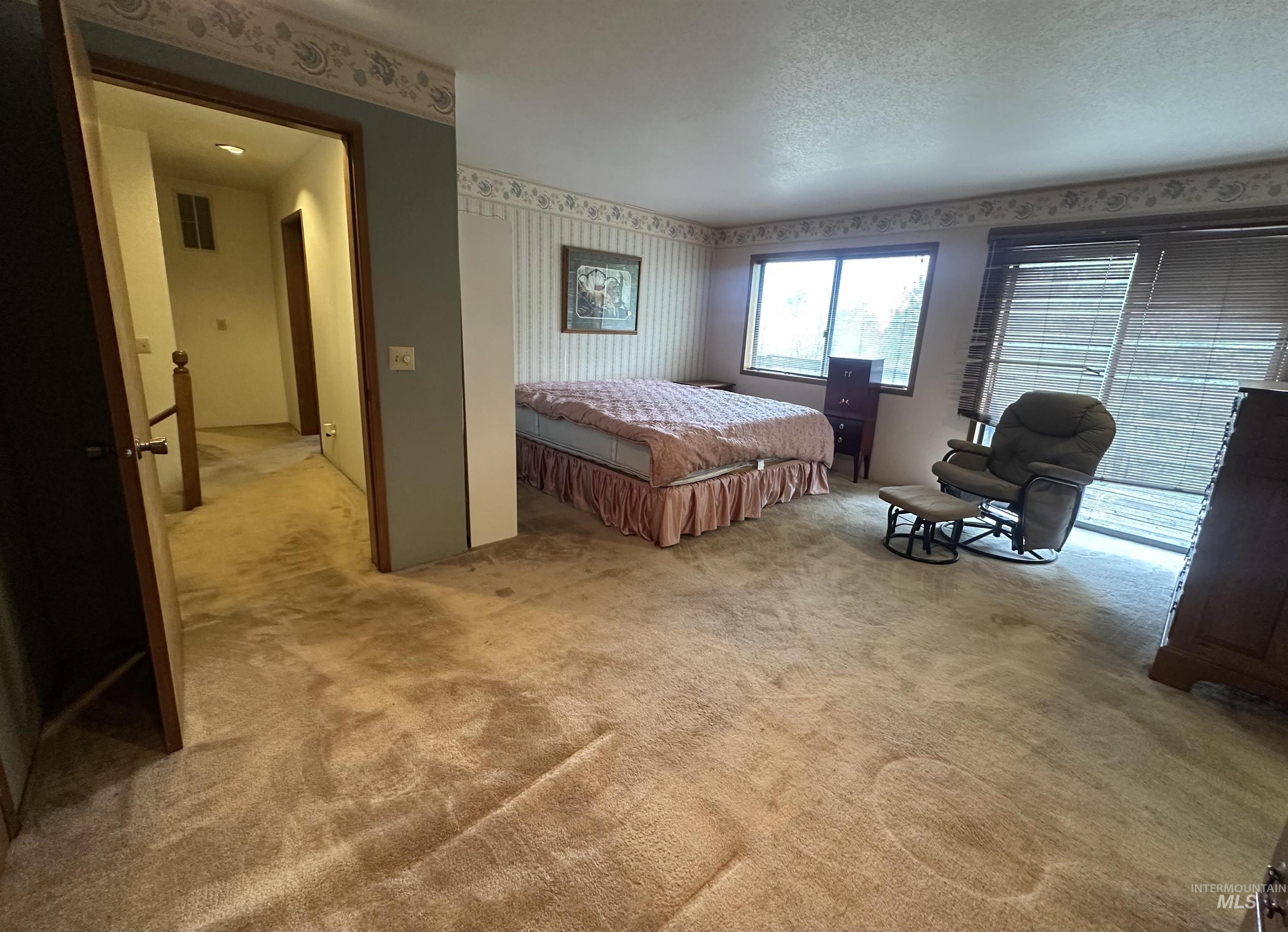 811 Florence Avenue Craigmont, ID 83523 - Photo 35 of 48 Bedroom with wallpapered walls and light colored carpet