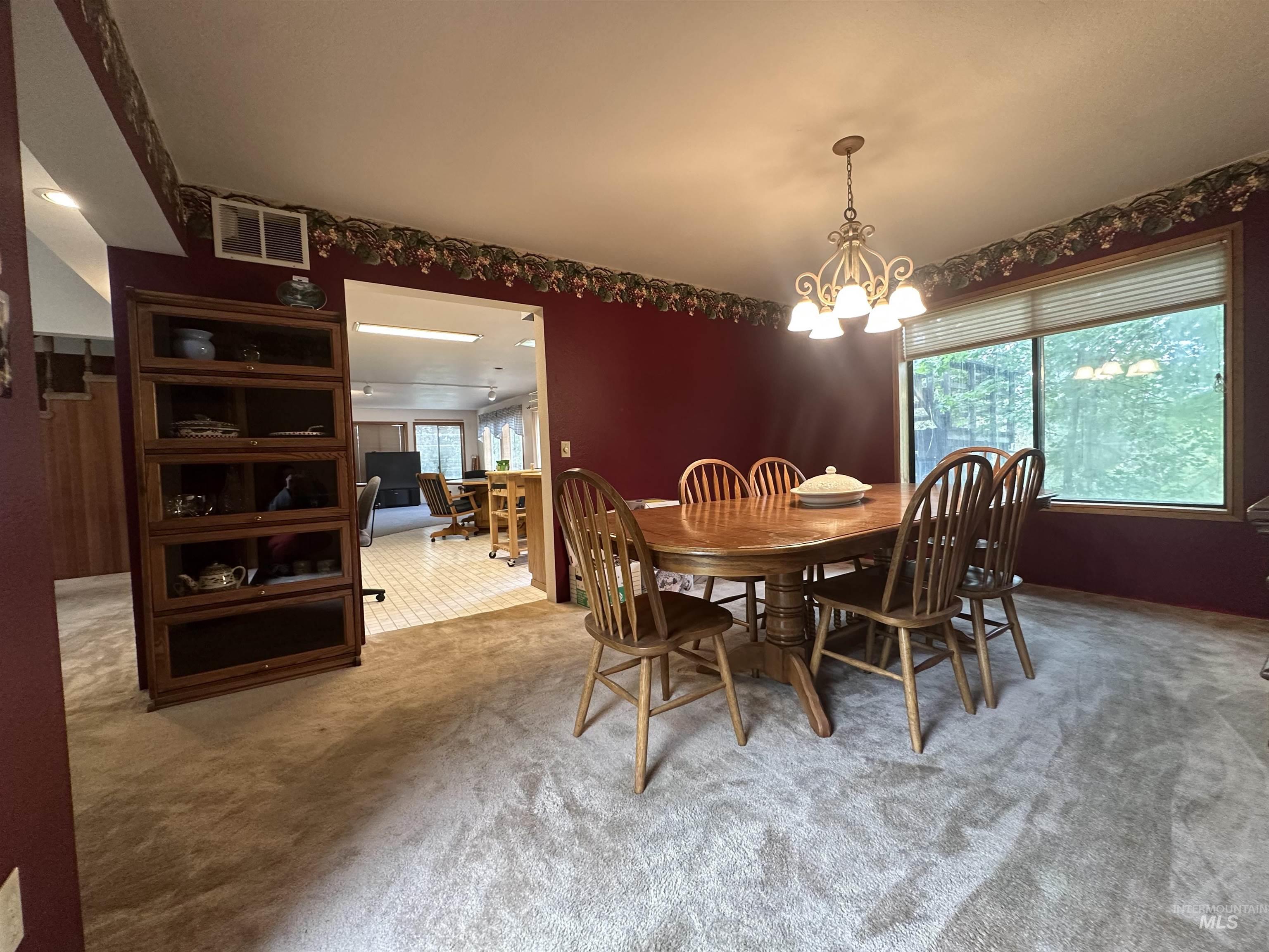811 Florence Avenue Craigmont, ID 83523 - Photo 10 of 48 Carpeted dining area with a chandelier