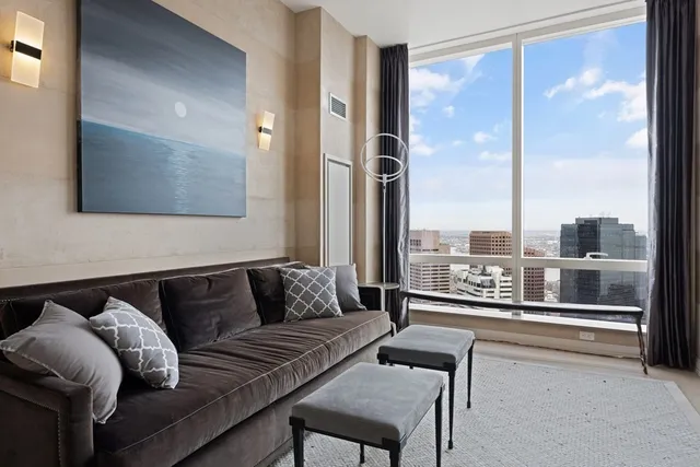 a living room with furniture and a floor to ceiling window