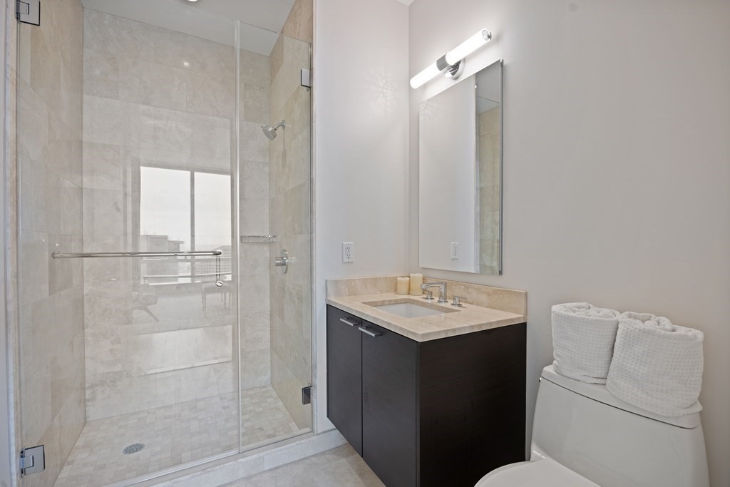1 Franklin Street, Unit 5204 Boston, MA 02110 - Photo 16 of 40 a bathroom with a sink a toilet and shower
