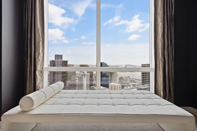 a view of a balcony with white furniture