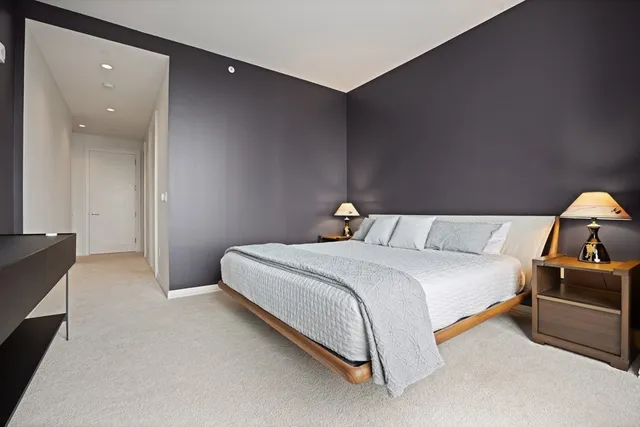 a bedroom with a bed and lamp