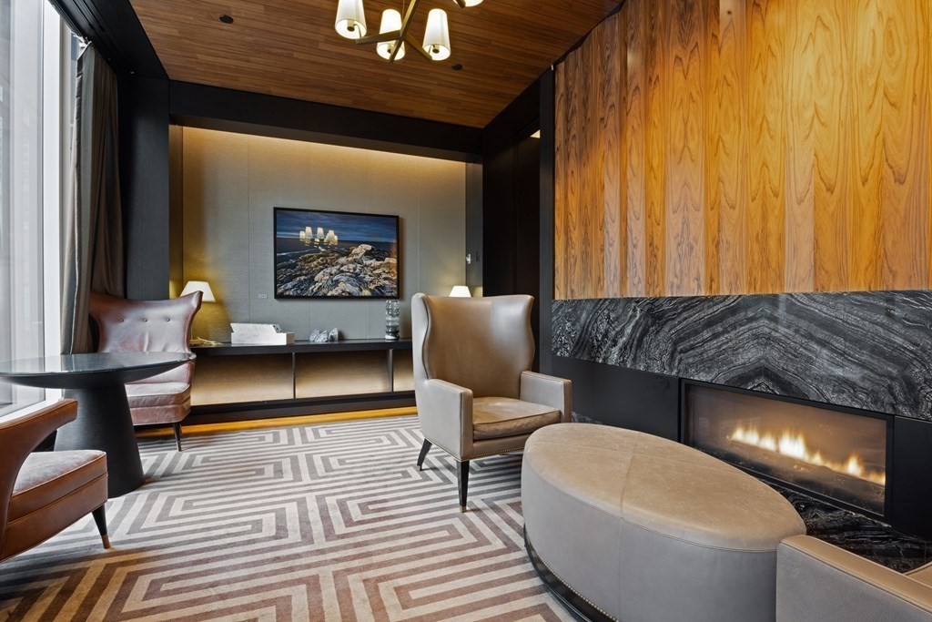 1 Franklin Street, Unit 5204 Boston, MA 02110 - Photo 35 of 40 a living room with furniture a lamp and a rug