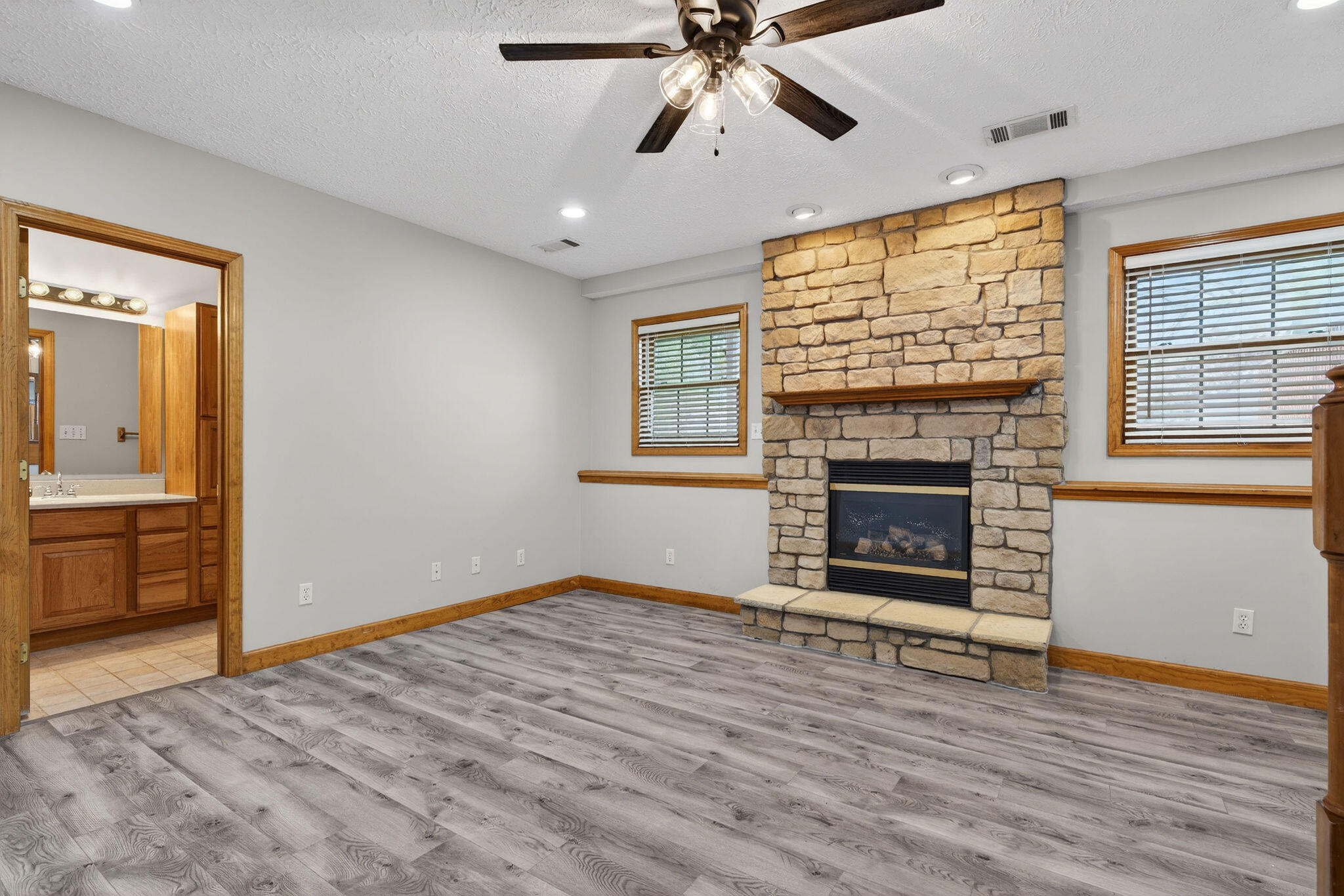 2447 Joseph Avenue Portage, IN 46368 - Photo 22 of 33 wooden floor fireplace and windows in an empty room