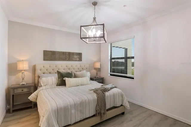 a bedroom with a bed and a painting on the wall