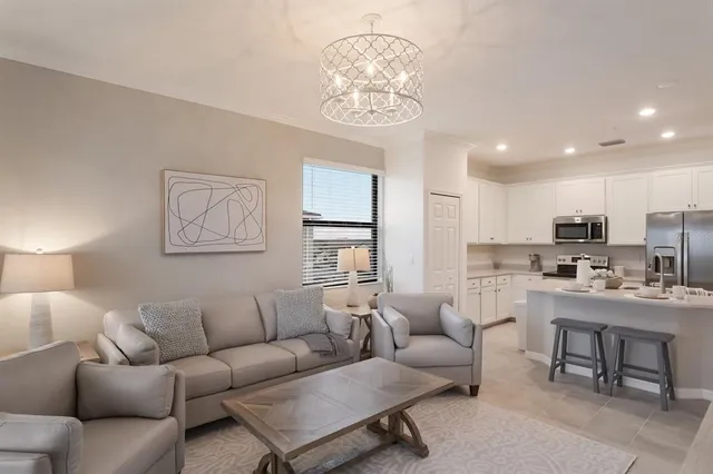 a living room with furniture a window and a table