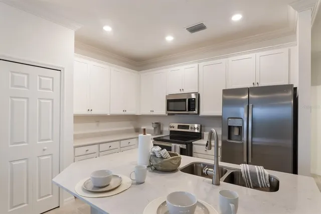 a kitchen with a refrigerator and a sink
