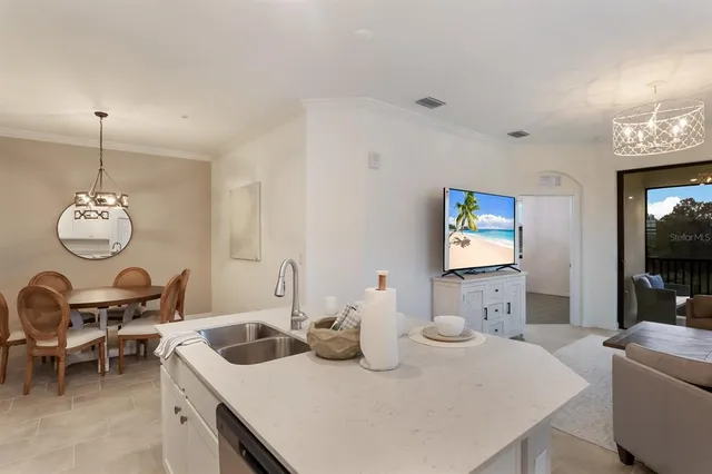a view of a dining room with furniture and a chandelier