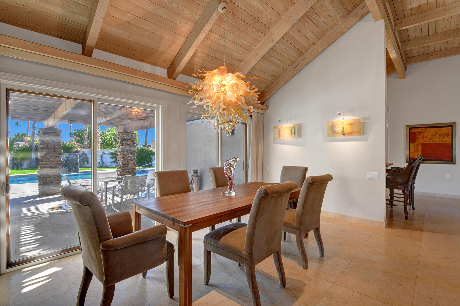 4 Boothill Circle Rancho Mirage, CA 92270 - Photo 23 of 55 a view of a dining room with furniture wooden floor and a chandelier