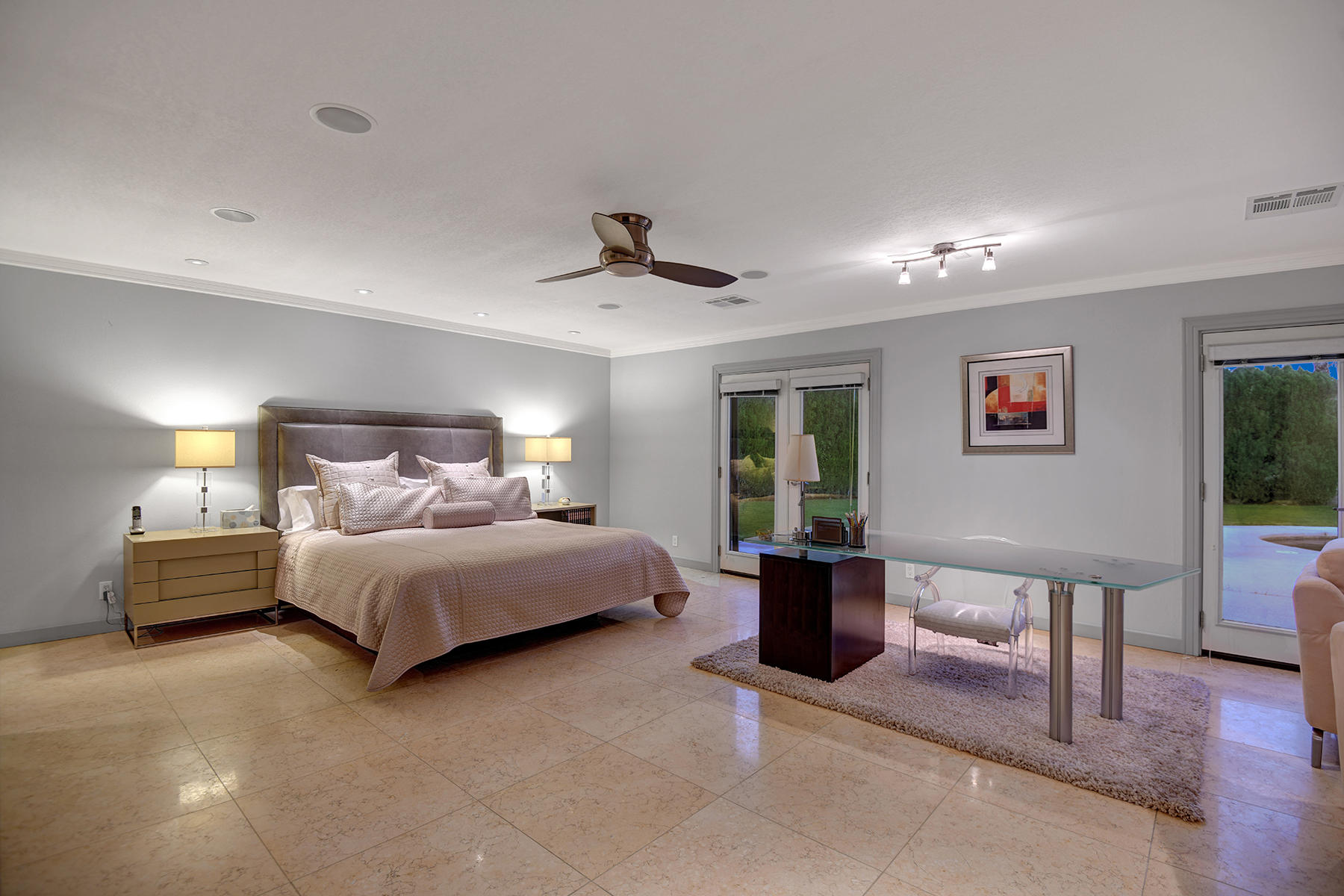 4 Boothill Circle Rancho Mirage, CA 92270 - Photo 28 of 55 a bed room with a bed and a chandelier