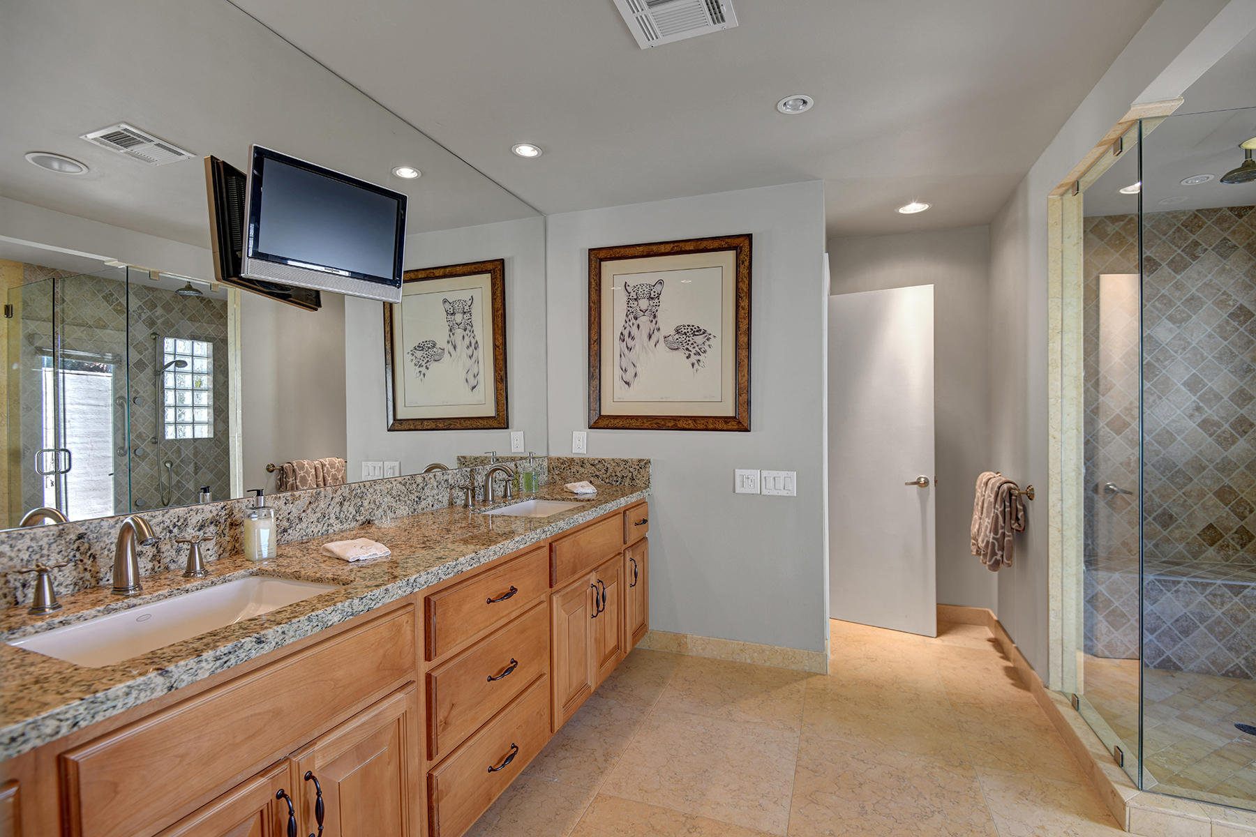 4 Boothill Circle Rancho Mirage, CA 92270 - Photo 32 of 55 a spacious bathroom with a double vanity sink and a mirror