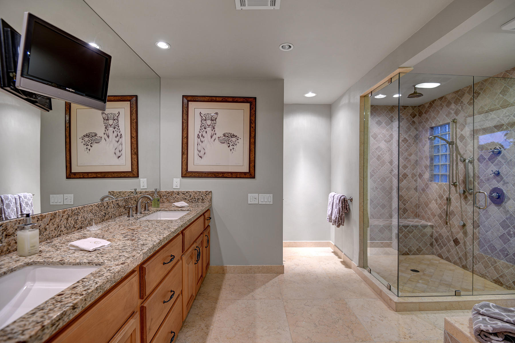 4 Boothill Circle Rancho Mirage, CA 92270 - Photo 33 of 55 a spacious bathroom with a granite countertop sink mirror and shower