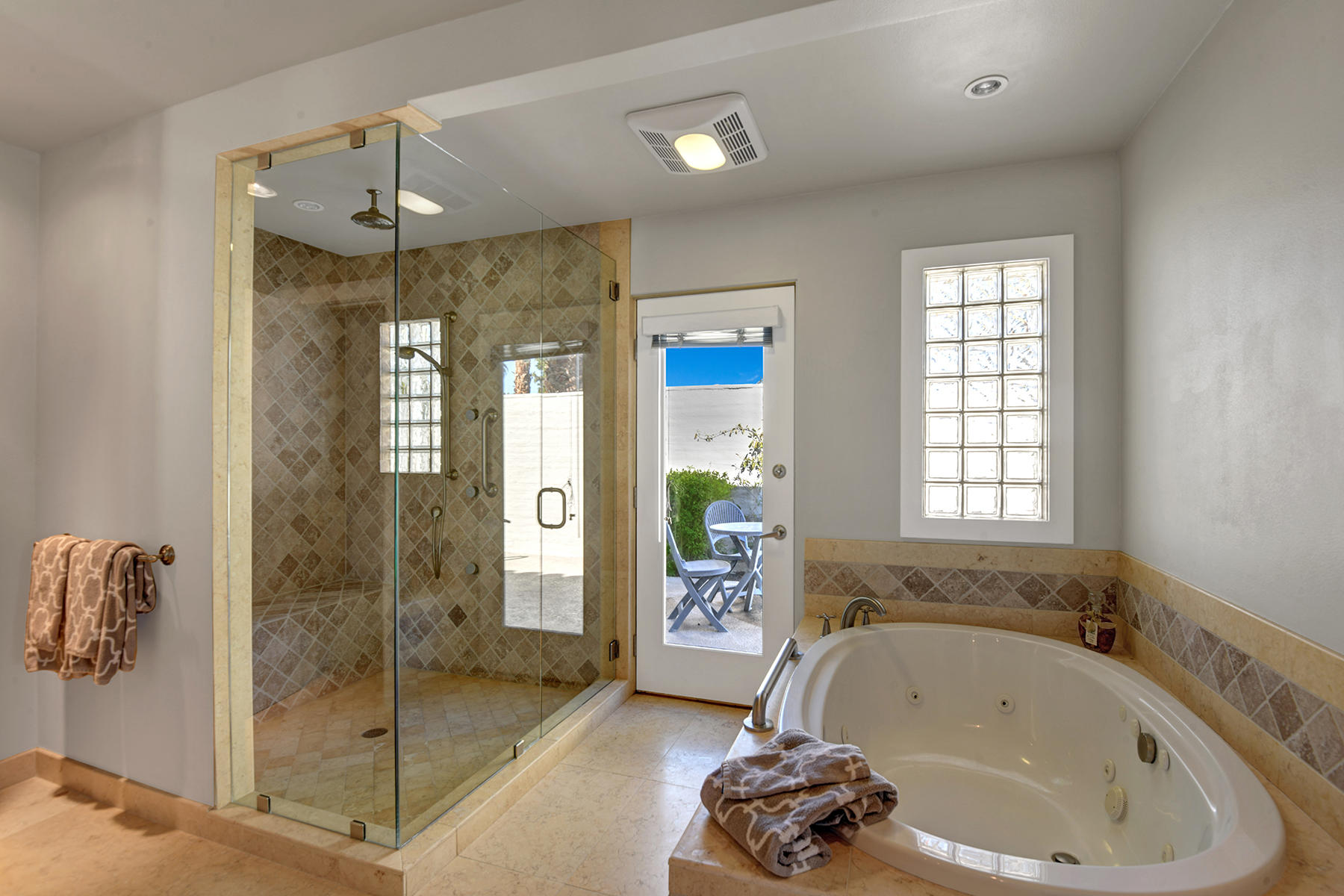 4 Boothill Circle Rancho Mirage, CA 92270 - Photo 34 of 55 a bathroom with a tub a sink and glass door shower