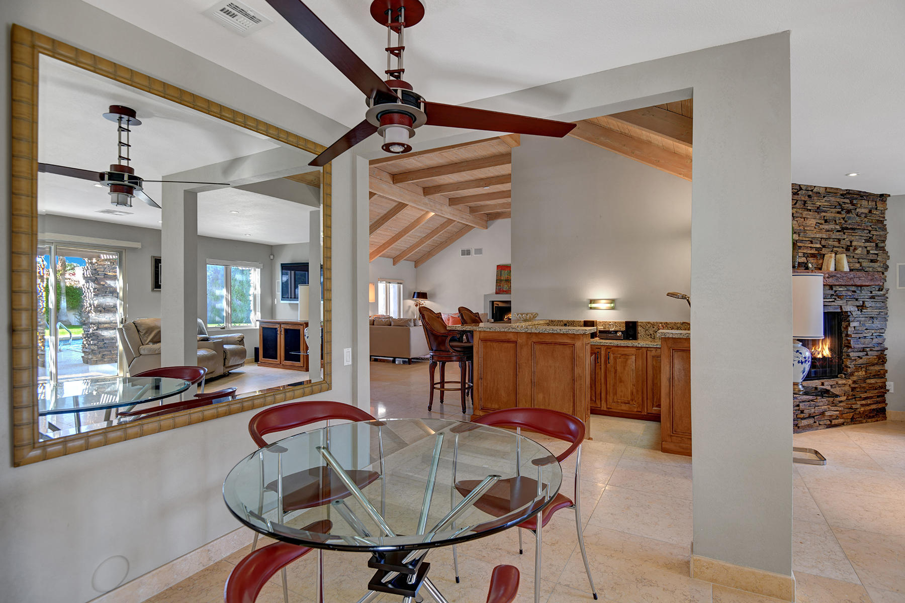 4 Boothill Circle Rancho Mirage, CA 92270 - Photo 41 of 55 a dining room with furniture and a chandelier