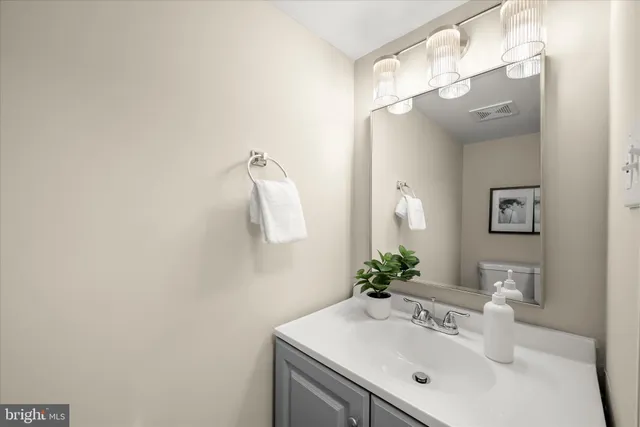 a bathroom with a sink vanity and a mirror