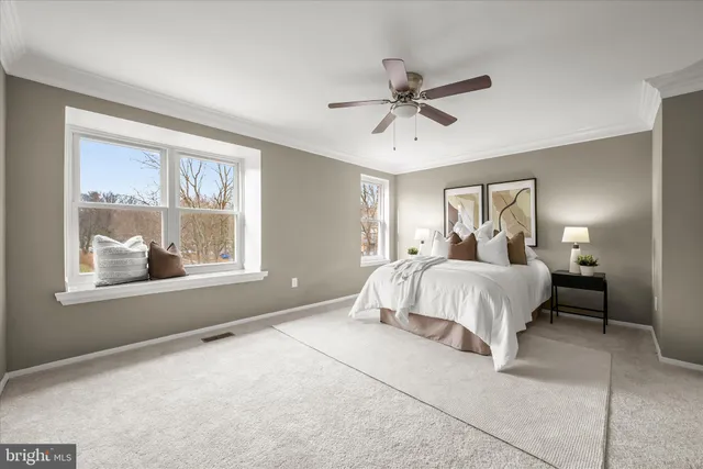 a bedroom with a large bed and a window