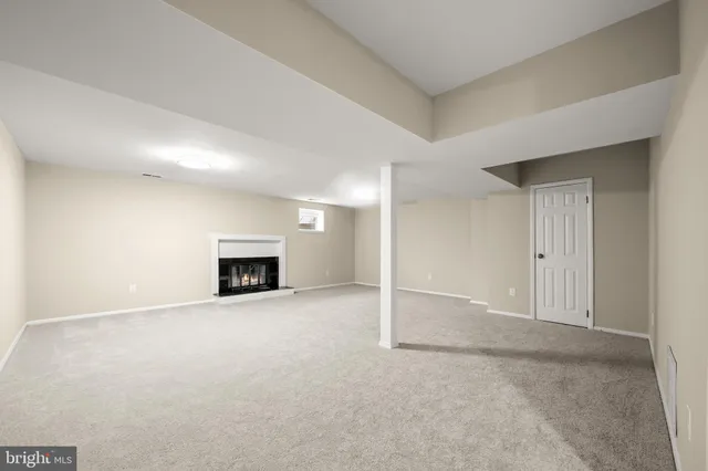 an empty room with a fireplace