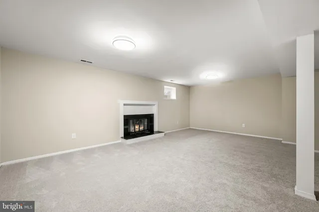an empty room with a fireplace