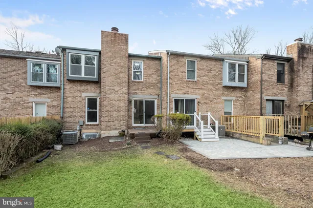 a front view of a house with garden and patio
