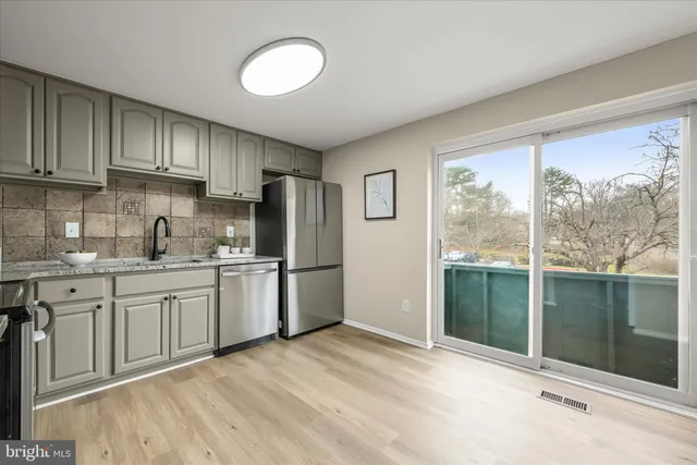 a kitchen with a refrigerator and window