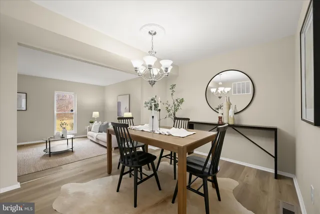 a view of a dining room with furniture and chandelier