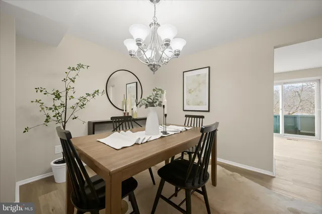 a view of a dining room with furniture and chandelier