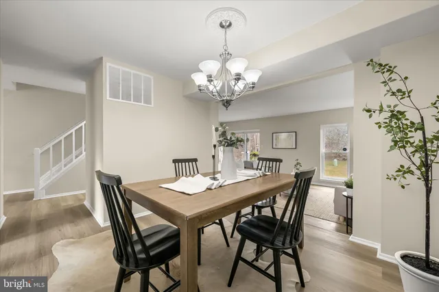 a view of a dining room with furniture wooden floor and chandelier