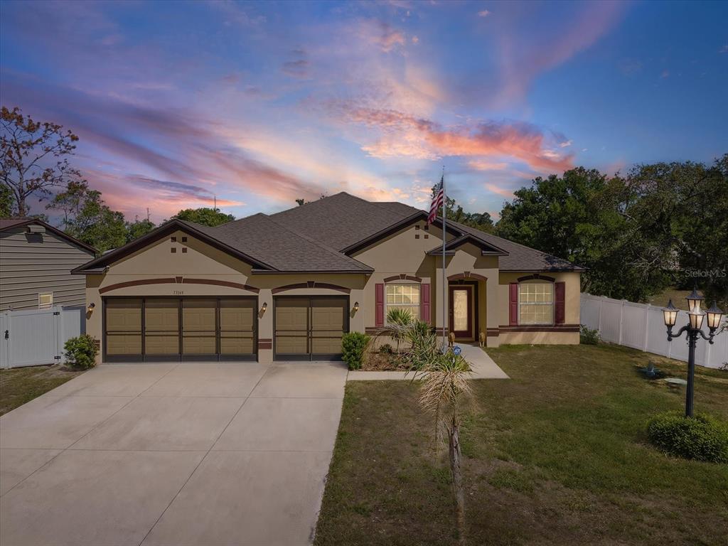 13169 Santee Street Spring Hill, FL 34609 - Photo 1 of 58 front view of a house with a yard