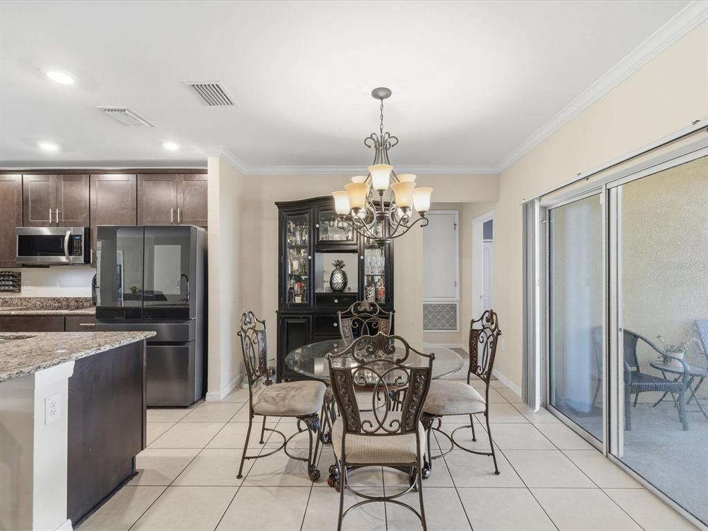 13169 Santee Street Spring Hill, FL 34609 - Photo 11 of 58 a view of a dining room with furniture and chandelier