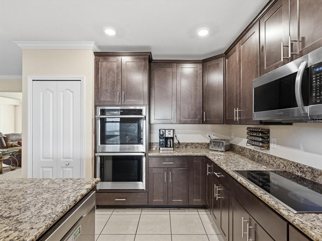 13169 Santee Street Spring Hill, FL 34609 - Photo 15 of 58 a kitchen with a sink stainless steel appliances and cabinets