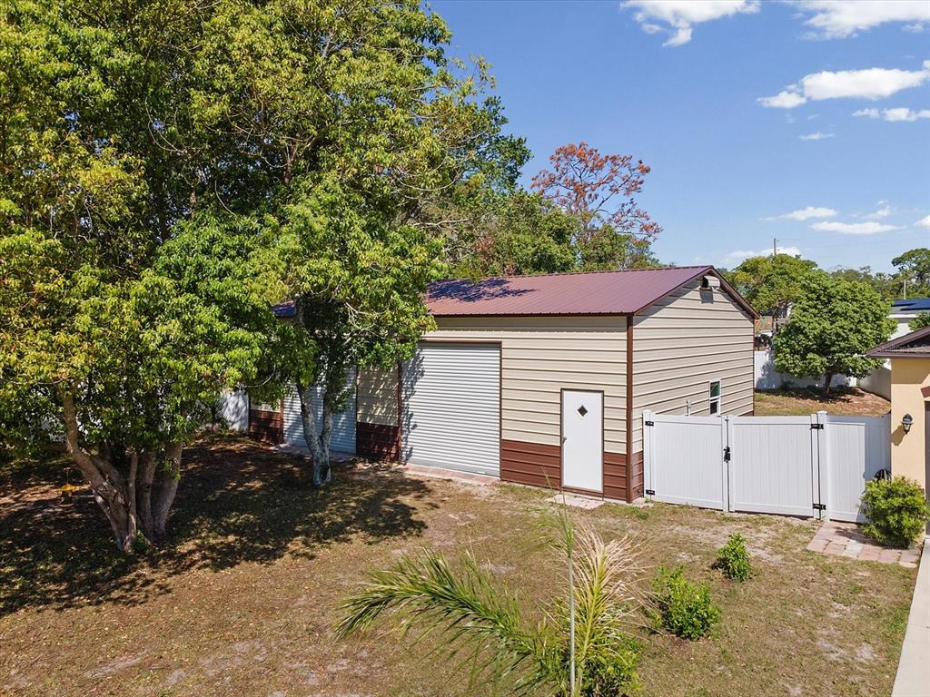13169 Santee Street Spring Hill, FL 34609 - Photo 2 of 58 a front view of a house with a yard and garage