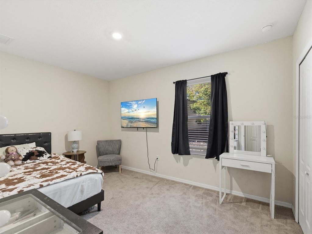 13169 Santee Street Spring Hill, FL 34609 - Photo 21 of 58 a bedroom with a bed and a table