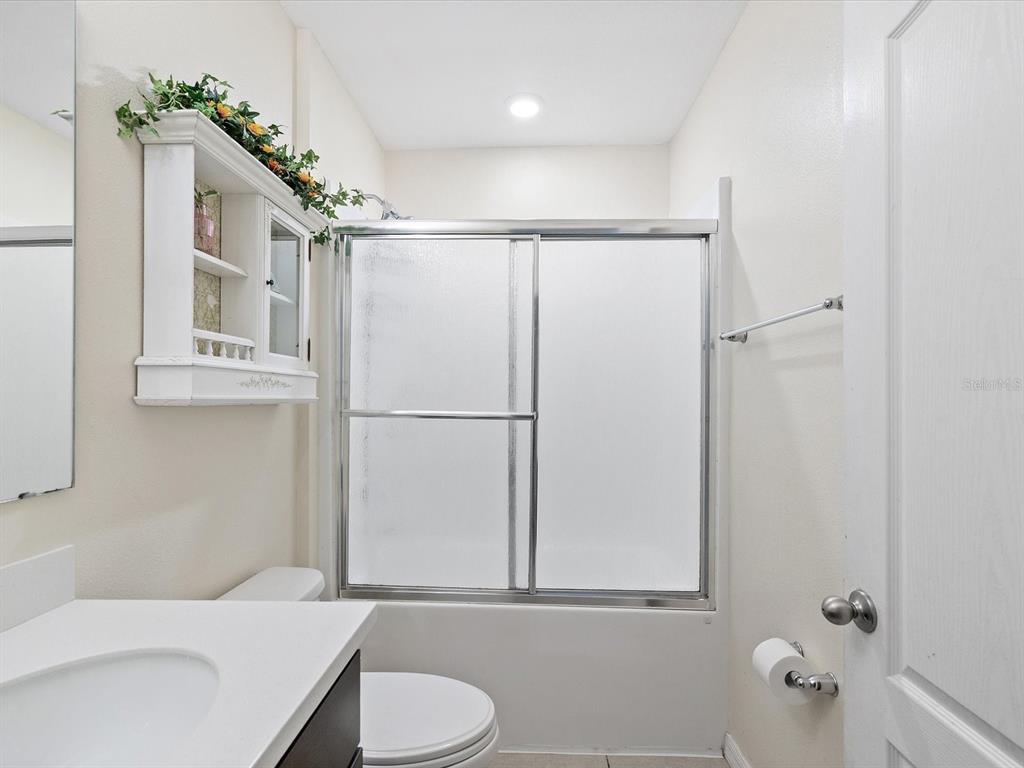 13169 Santee Street Spring Hill, FL 34609 - Photo 23 of 58 a bathroom with a toilet a sink and shower