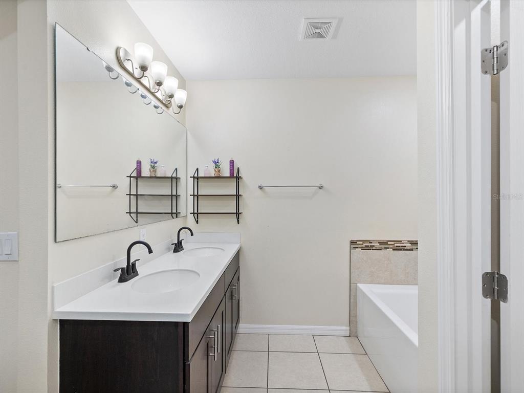 13169 Santee Street Spring Hill, FL 34609 - Photo 28 of 58 a bathroom with a sink and a mirror