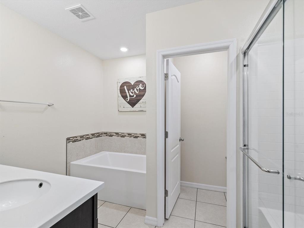 13169 Santee Street Spring Hill, FL 34609 - Photo 29 of 58 a bathroom with a bathtub and a shower