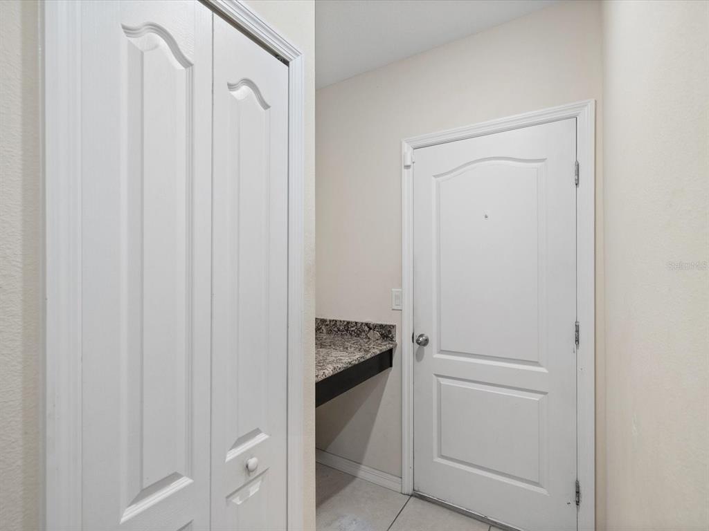 13169 Santee Street Spring Hill, FL 34609 - Photo 32 of 58 a bathroom with a granite countertop sink and vanity