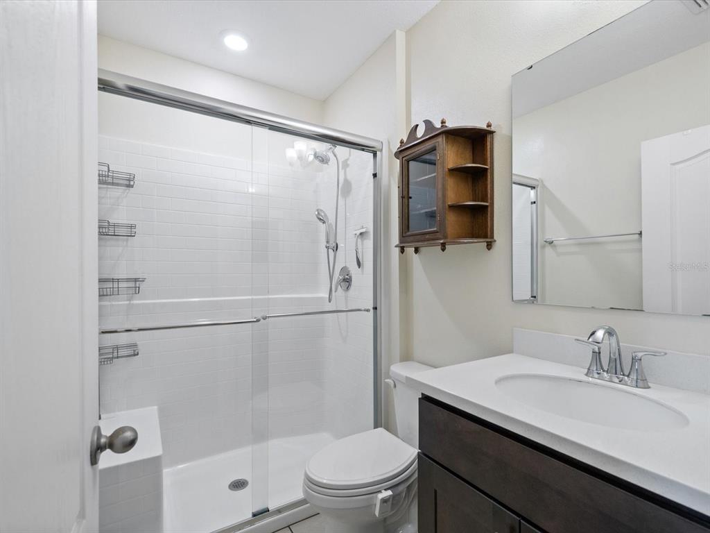 13169 Santee Street Spring Hill, FL 34609 - Photo 37 of 58 a bathroom with a sink toilet and shower