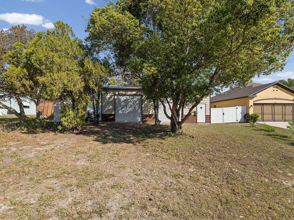 13169 Santee Street Spring Hill, FL 34609 - Photo 51 of 58 a front view of a house with a yard