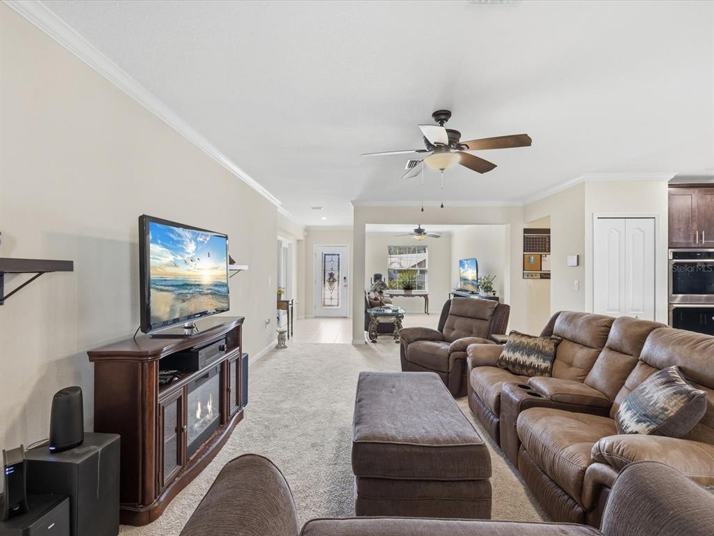 13169 Santee Street Spring Hill, FL 34609 - Photo 7 of 58 a living room with furniture and a flat screen tv