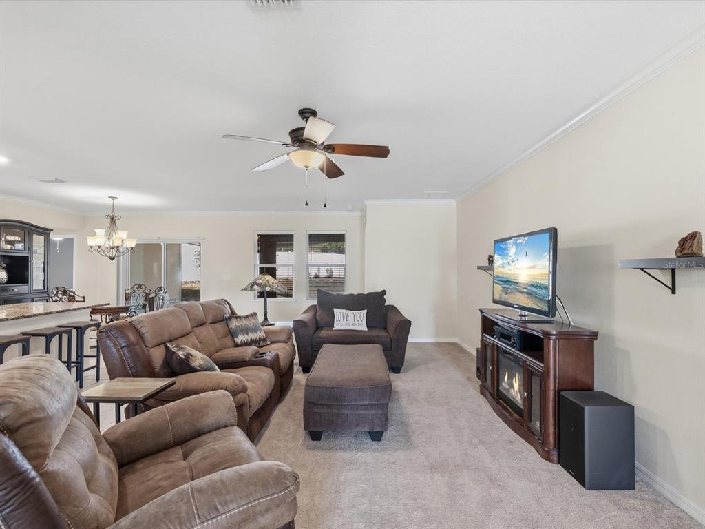 13169 Santee Street Spring Hill, FL 34609 - Photo 10 of 58 a living room with furniture and a flat screen tv