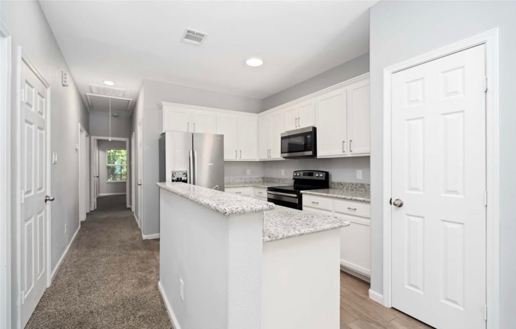 5101 Southwind Street Houston, TX 77033 - Photo 4 of 11 a kitchen with stainless steel appliances a refrigerator sink stove microwave and cabinets