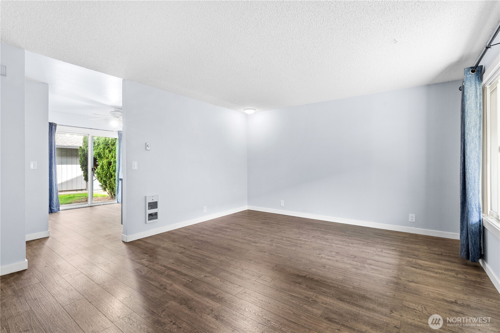 5304 Northeast 84th Loop, Unit 16 Vancouver, WA 98662 - Photo 6 of 22 a view of an empty room with wooden floor and a window