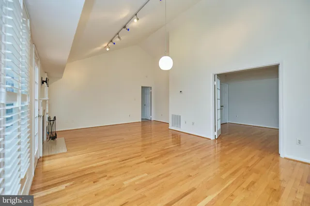 a view of an empty room with a fireplace and a window